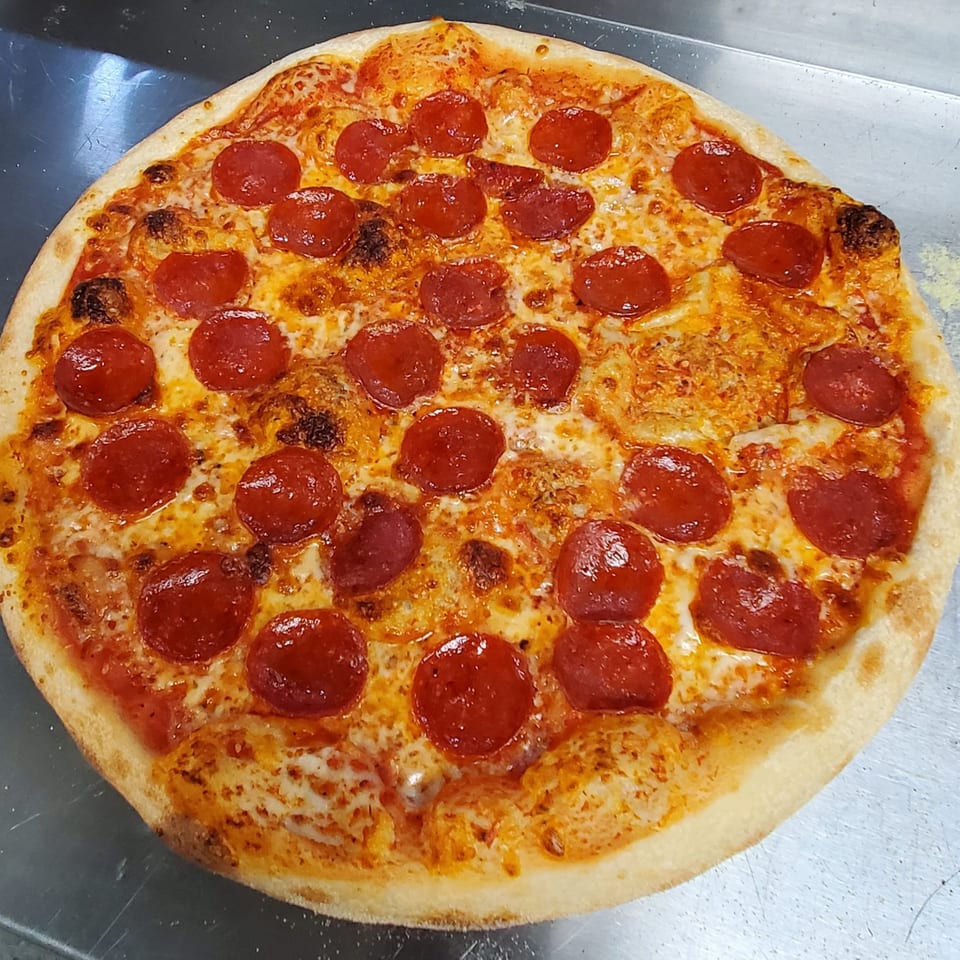 A freshly baked pepperoni pizza from Eastside Market LLC, with melted cheese and a golden crust.